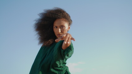 Woman performing dance nature windy day close up. African american girl dancing.