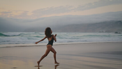 Woman performer dancing beach at summer twilight. Girl performing contemporary.
