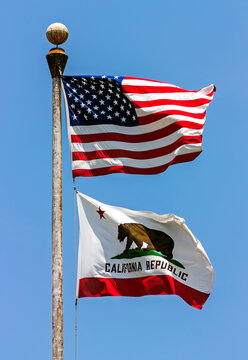 State flag of California - United States of America on blue sky.