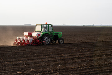 Sowing crops at agricultural fields in spring