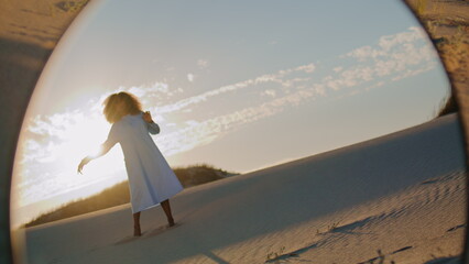 Fototapeta na wymiar Girl artist dancing sunset sky reflecting in mirror. Woman performing at desert.