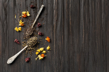 Dry green and black tea, flower tea on a dark background top view copy space.