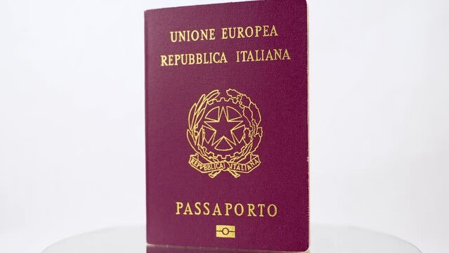 red coated italian passport isolated on white background rotating platform