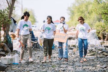Volunteering people help to picking plastic and foam garbage on park area. World environment day concept for save the earth from pollution.