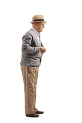 Full length shot of a senior gentleman buttoning his cardigan