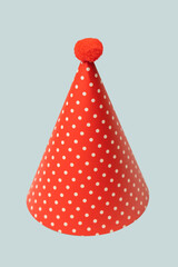 Bright and colorful birthday cap isolated on a blue background.