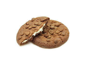 Chocolate chip cookies filled with milk cream isolated on white background. Whole and broken biscuits
