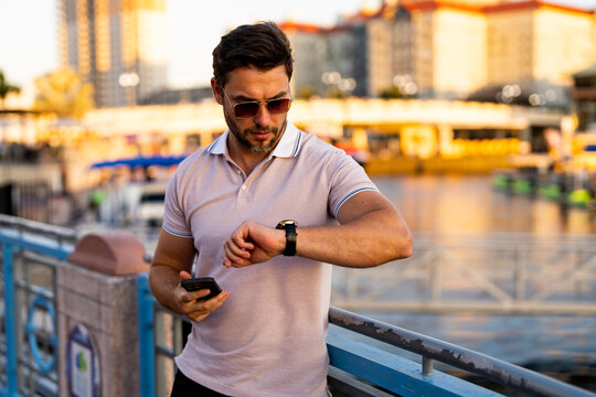 Portrait Of Handsome Confident Stylish Man In Big City. Sexy Man In Casual Clothes Posing On The Street. Successful Male Model In The Urban Lifestyle. Caucasian Middle Aged Man Outdoors.