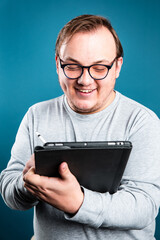 smiling man writing on tablet computer