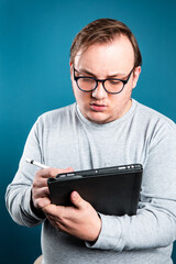 man writing on tablet computer