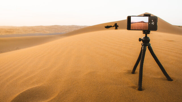 Tourist walk on sand dunes and capture moments on sunset in KAshan desert outdoors in Iran countryside
