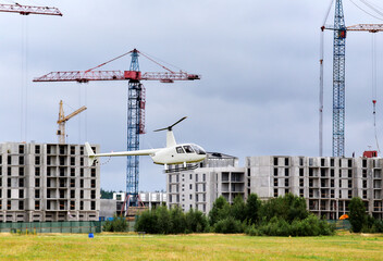Panoramic view of construction sites and many working cranes