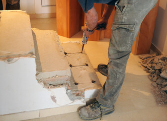 Carpenter preparing the stairs of a house with high-resistance silicone to glue the beech wood...