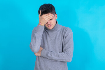 young man isolated on background with sorry expression