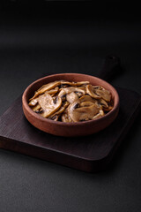 Fried or stewed champignon mushrooms in the form of slices with onions
