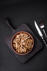 Fried or stewed champignon mushrooms in the form of slices with onions
