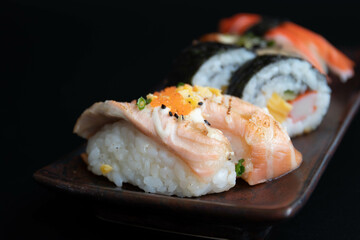 Mixed Japanese food, Sushi Roll, on black background