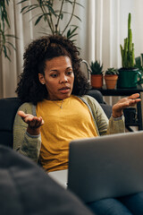 Fototapeta premium A mixed race woman is giving some explanation over the video call