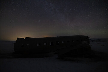 Amazing natural phenomenon called aurora borealis at the famous plane wreck in Iceland.
