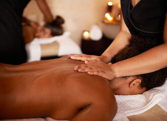 Status update Unavailable. a massage therapist giving a woman a massage at a day spa.