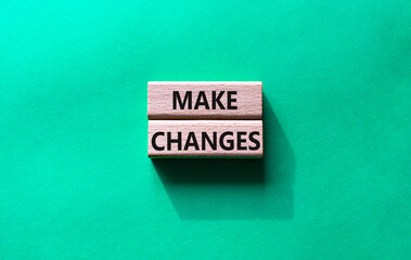 Make changes symbol. Wooden blocks with words Make changes. Beautiful green background. Business and Make changes concept. Copy space.