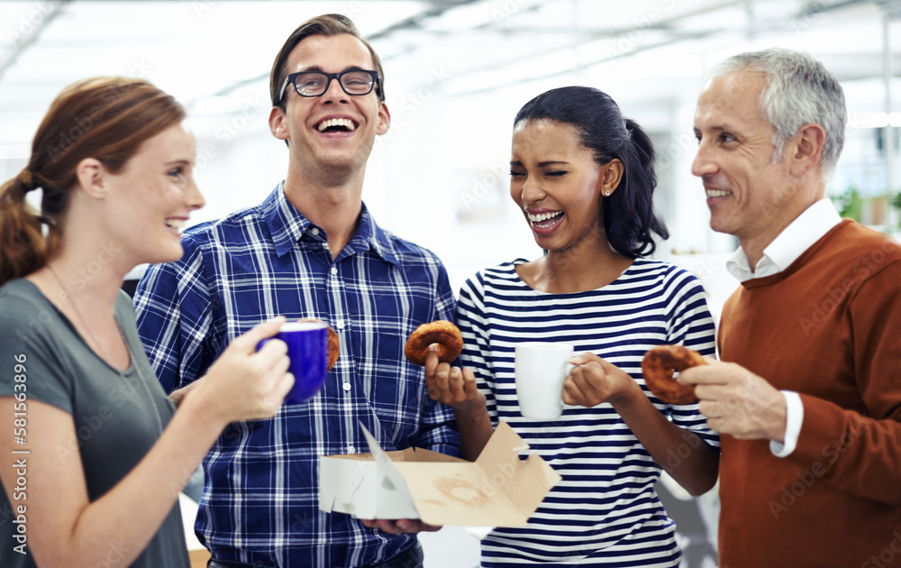 Poster time for a coffee break. a diverse group of business professionals enjoying doughnuts on a coffee br