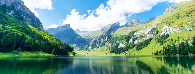 Fototapeta na wymiar Lake in the Swiss Alps. Panoramic view of the nature and mountains of Switzerland.
