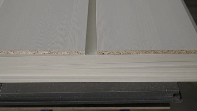 Samples of chipboard and MDF panels for furniture production. Samples of finishing material based on chipboard and MDF, close-up.