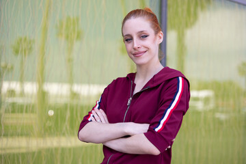 Portrait of Young woman with red hair on urban background