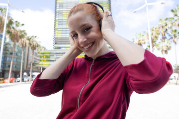 Close-up portrait of Young red-haired woman with headphones