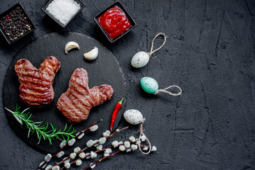 Easter grilled beef steaks in the shape of a rabbit on a stone background with copy space for your text