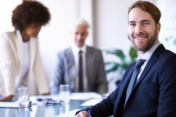 Getting the job done with teamwork. a group of business colleagues meeting in the boardroom.