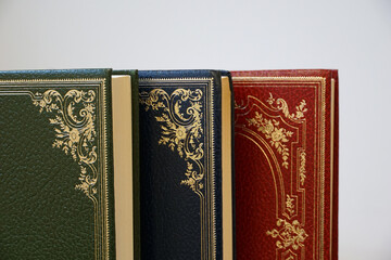 Green, blue and red corner of the vintage books on the white empty space background