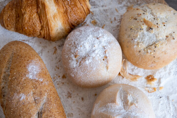 Freshly baked sourdough baked goods with golden crust on bakery shelves.