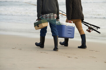 Well-equipped for some fishing. two men going fishing in the early morning.