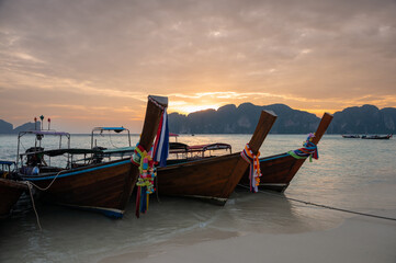 Traditional Thai longtail boats at sunset. Long Beach, Phi Phi island, Krabi Province, Andaman Sea.