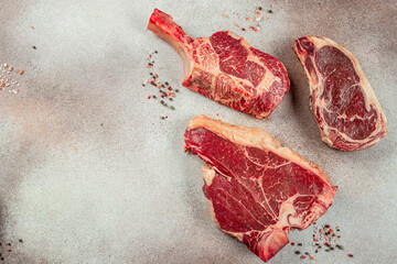 Variety of Raw Black Angus Prime meat steaks T-bone, tomahawk, New York steak. Set raw marbled beef...