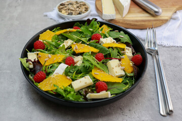 fresh green salad with oranges and brie cheese 