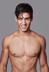 Hes one fine looking guy. Portrait of a handsome young shirtless man posing in the studio.