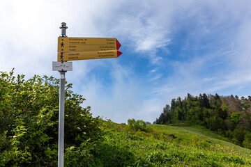 Yellow trail signpost showing direction to Tekenteri Cave, Tvishi and Okureshi on a trail to Khvamli Mounatin in Racha region in Georgia.