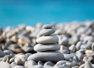 Pyramid of grey sea stones on seacoast