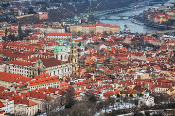 Prague, Czech Republic. Mala Strana district with St. Nicholas Church in winter. Hight angle view from the lookout tower at Petrin Hill.