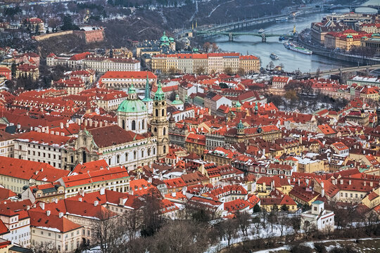 Prague, Czech Republic. Mala Strana district with St. Nicholas Church in winter. Hight angle view from the lookout tower at Petrin Hill. - Powered by Adobe