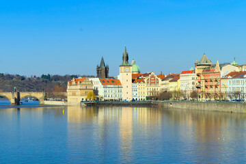 View of the embankment of the Vltava River in Prague, historical buildings, Charles Bridge