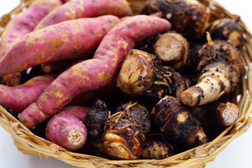 Sweet potato with taro in bamboo basket on white background.