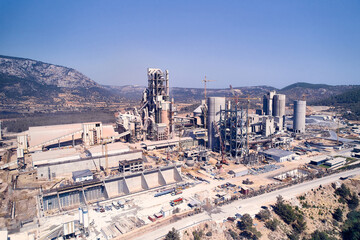 Structures of cement producing plant. Aerial view of huge industrial factory. 