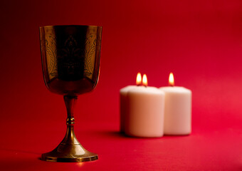 christian chalice burning candles red background