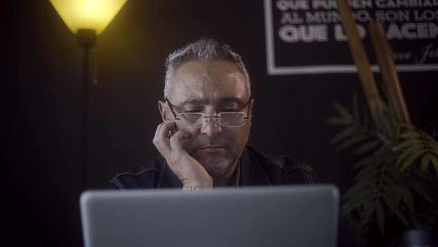 Close up Latin Freelancer receiving disappointing news on his computer