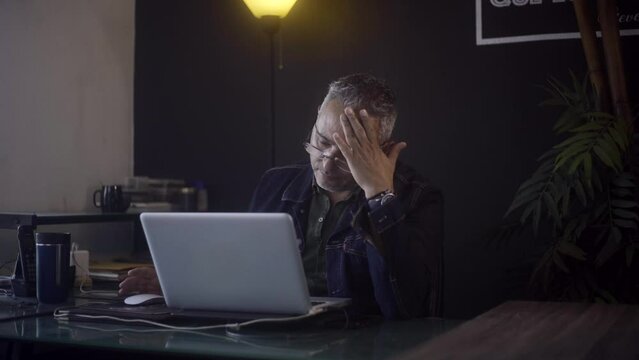 Freelancer receiving disappointing news on his computer