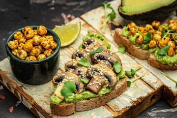 Mashed avocado, mushrooms and chickpea toasts. Delicious breakfast or snack, Clean eating, dieting, vegan food concept. top view